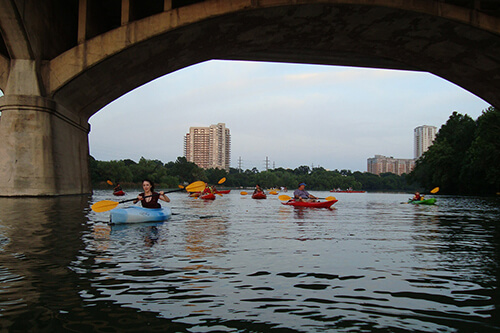 Kayaks under bridge